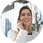 A woman smiles while holding a tablet computer, showcasing a positive and engaging expression.