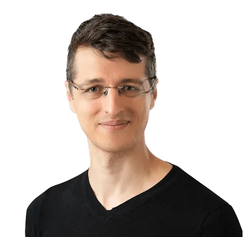 A man wearing glasses and a black shirt, looking directly at the camera with a neutral expression.