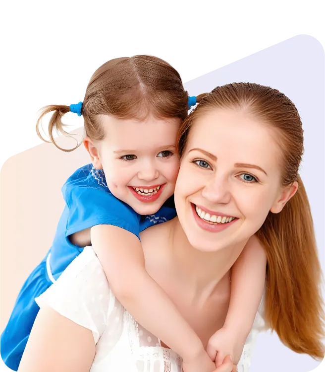 A woman and a child embrace each other, both smiling warmly at the camera.